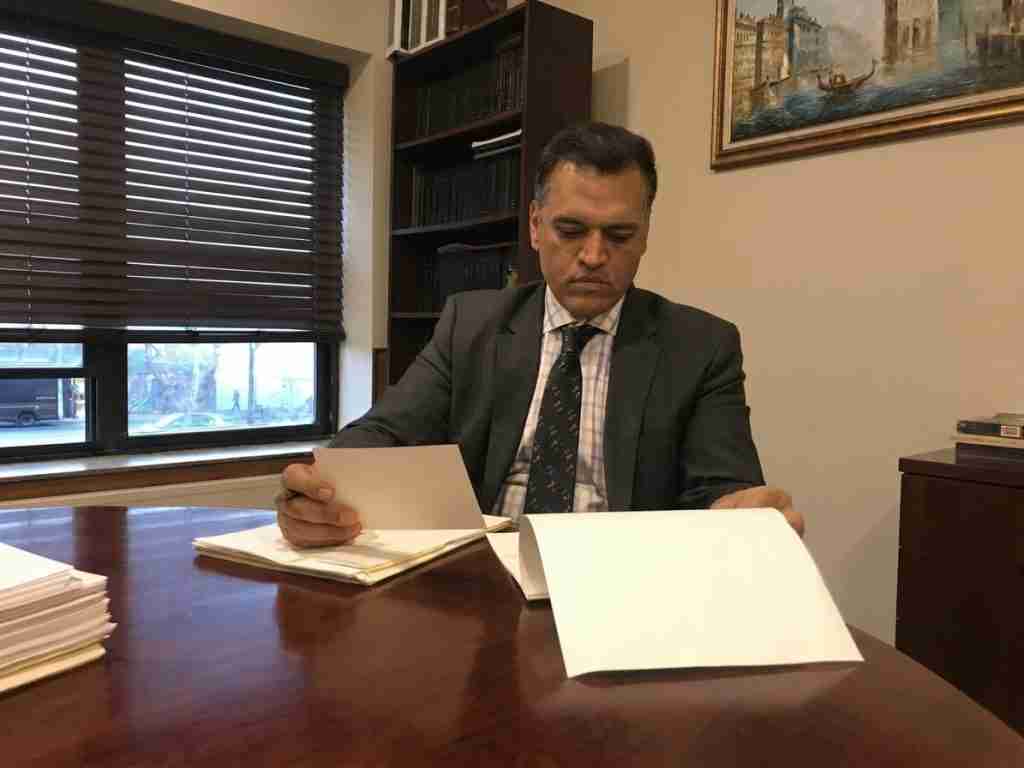 neil kalra at desk reviewing legal papers